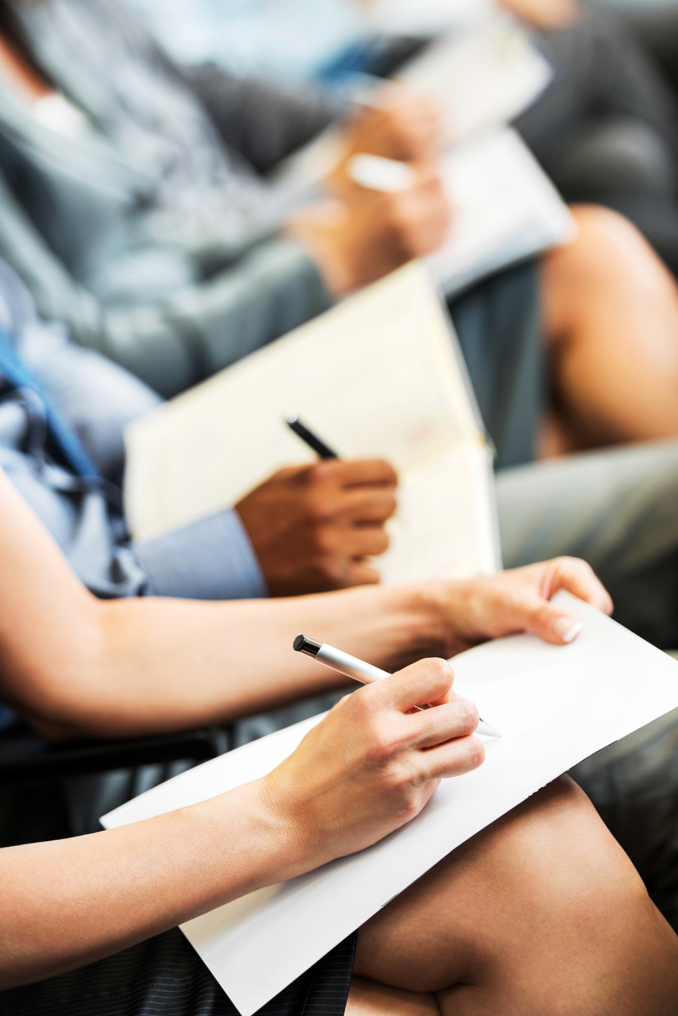 People writing on a seminar.